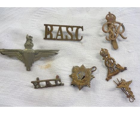 Seven British Army corps badges including Parachute Regiment cap badge, Royal Armoured Corps shoulder badge, Provost Staff Co