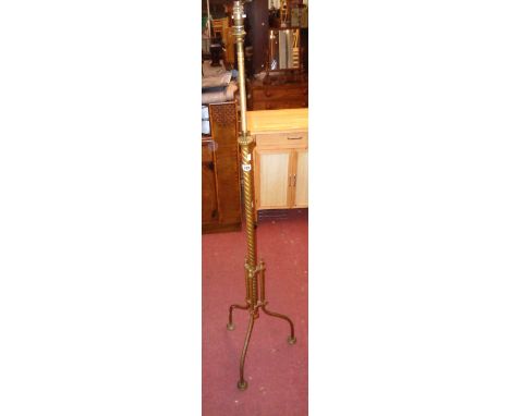A late Victorian brass telescopic oil lamp standard with twist column and tripod base - converted to electricity