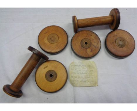 A set of four coasters and a pair of candlesticks made from First World War period uniform factory bobbin parts - see paperwo
