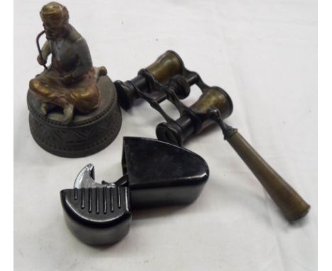 A box containing a cold painted spelter figure of an Eastern gentleman smoking a pipe, a bakelite cased Wilkinson safety razo
