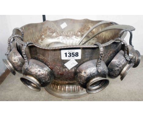 A 12 1/2" diameter silver plated copper footed punch bowl with flanking lion mask ring handles, six cups and two associated l