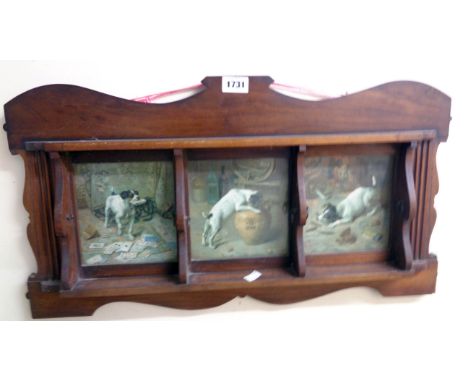 An early 20th Century walnut shelf rack with three sections decorated with humorous images of terriers, relating to gambling,