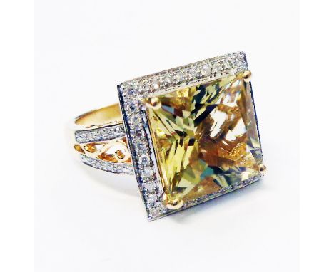 A hallmarked 585/14k ornate ring, set with central square cut citrine within a diamond encrusted border with further diamonds