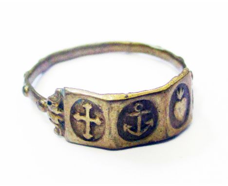 An antique yellow metal ecclesiastical ring decorated with central anchor motif flanked by sacred heart and cross