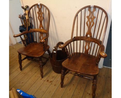 A pair of 20th Century Windsor style stained wood hoop stick back elbow chairs, with solid sectional seats, set on turned sup