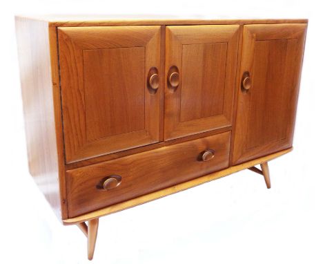 A 3' 7" Ercol light elm sideboard with three cupboard doors and single long drawer under all with recessed Windsor handles, s