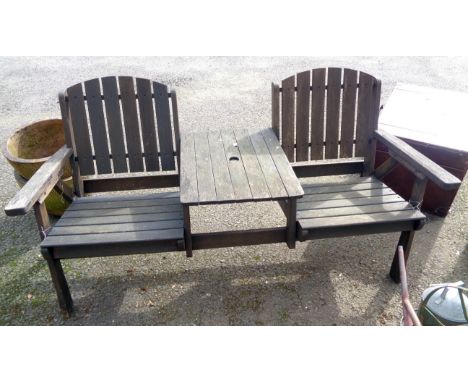 A two seater garden bench with central table