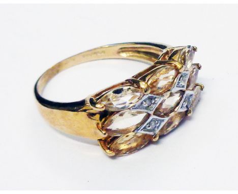 A hallmarked 375 gold ring, set with nine marquise cut pale citrine stones and four tiny diamonds