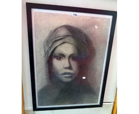 A large framed monochrome charcoal and pencil portrait of a woman wearing a head scarf 