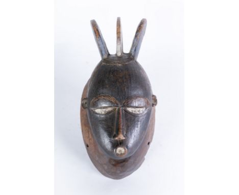 African art Portrait mask, BauleIvory Coast. . Cm 19,00 x 37,00. Dark patina wooden mask with traces of pre-existing polychro