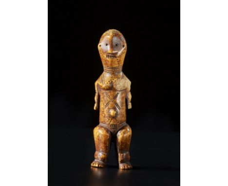 African art Standing figure, LegaD.R. Congo. . Cm 14,50. A rare carved ivory masango figure .This type of Lega ivory sculptur