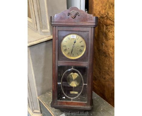 A 20th c. Mahogany cased Wall Clock having bevelled leaded glass to the door, a brass finished face with Roman numerals, the 