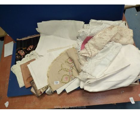 A quantity of linen including doilies, damask, leather pouch of handkerchiefs, black table runner with embroidered stylised f