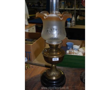 A brass Oil lamp on heavy plinth base with etched glass shade that tints to light brown at the petal shaped upper edge, 22 1/