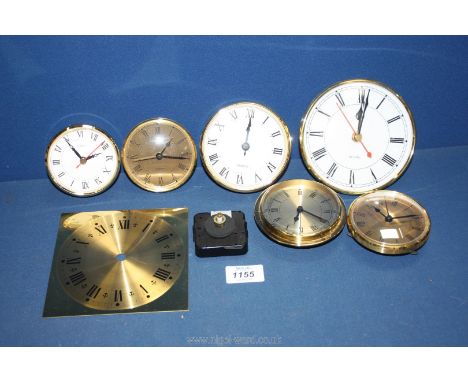 A quantity of small clock faces including quartz.