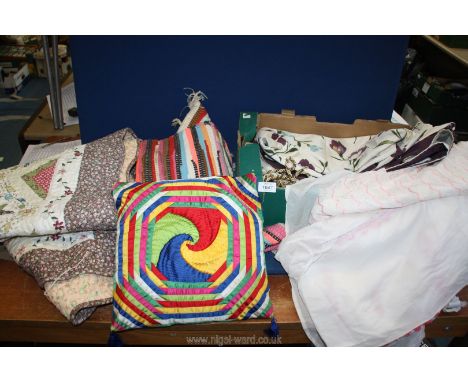 A pair of floral curtains together with a small patchwork quilt, small rug, cushions etc.