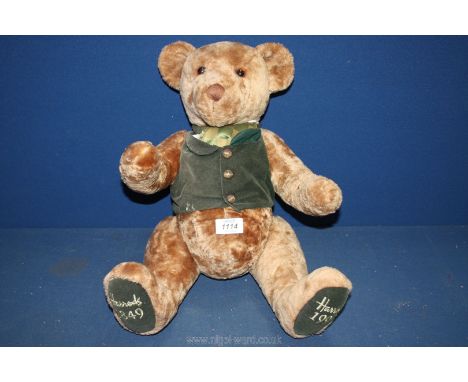 A jointed Harrod's Teddy Bear in light brown with green waistcoat, 20'' tall.
