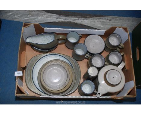 A pottery part dinner and tea service including large teapot, cups and saucers, gravy boat, meat plate, side plates, large sa