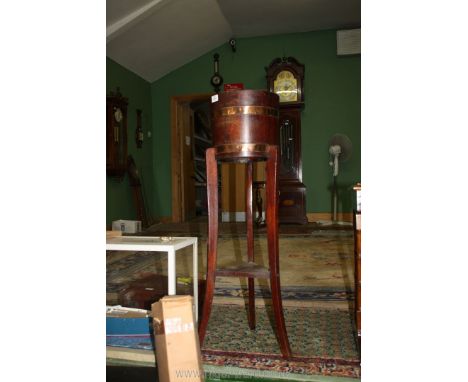 An arts and crafts Oak barrel type Planter stand by Lister having copper banding, the three legs united by a triangular lower