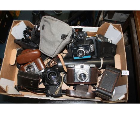 A box of cameras and camera parts including Chinon CE Memotron 35mm SLR camera, a Kodak folding Brownie, a Polaroid colour pa