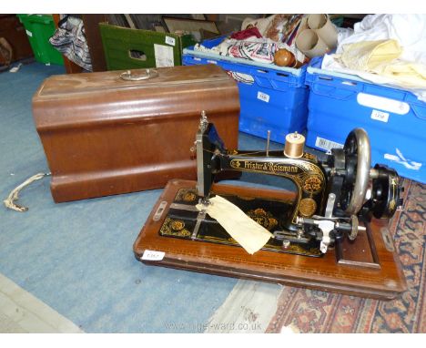 A Frister &amp; Rossmann manual sewing machine having floral decoration, including wooden case, with key (serial no. 3807412)