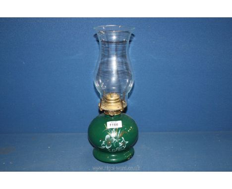 An oil Lamp with green ceramic base and glass chimney, 14" tall.