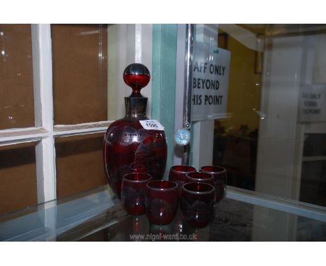 A ruby glass Venetian liqueur decanter and six glasses, all decorated with silver lustre and Venetian scenes.