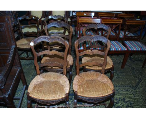 A set of four unusual seagrass seated Dining Chairs having ladder backs and carved top rail depicting a stylised flowering tw
