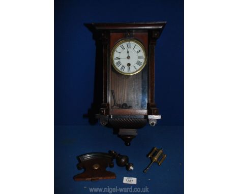 A darkwood and glass cased wall clock with key and pendulum, finials, a/f.