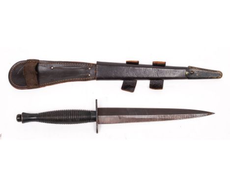 A post war copy of a Fairbairn Sykes Fighting knife by W M Rogers, Sheffield: in brown leather scabbard.