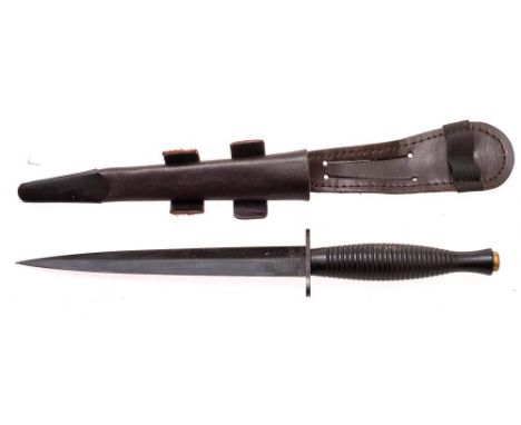 A Fairbairn Sykes pattern fighting knife: stamped 'Sheffield, England', with broad arrow mark to underside of hilt, cast one 