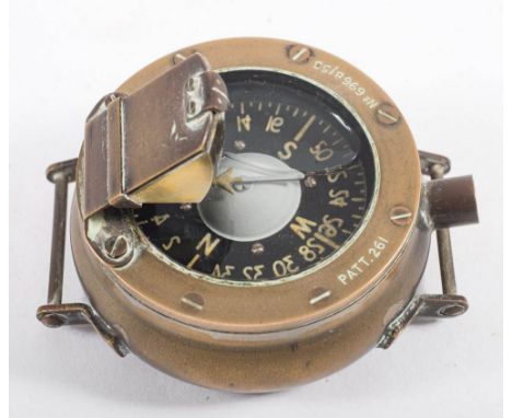 A Military pattern navigator/diver's wrist compass Pattern 261, No 696B/55:, with black liquid filled dial in a brass case wi