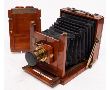 A Thornton Pickard mahogany and brass camera: fitted f8-64 brass lens, with black bellows and retailers plaque for 'The Photo