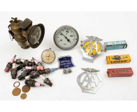 A blue enamel 'The Vintage Motorcycle Club' bar badge: together with two AA badges, a collection of vintage spark plugs, an A