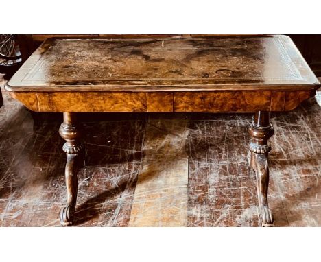 An early Victorian burr walnut library table, circa 1850, rectangular rounded edge top with leather writing surface, above tw