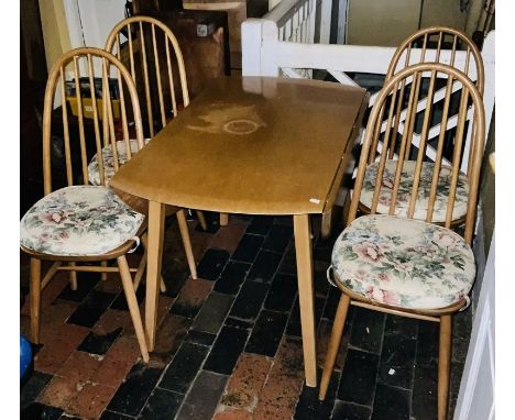 An Ercol design dining table and four chairs, blonde colour, dropleaf dining raised swept tapered supports and hooped back di