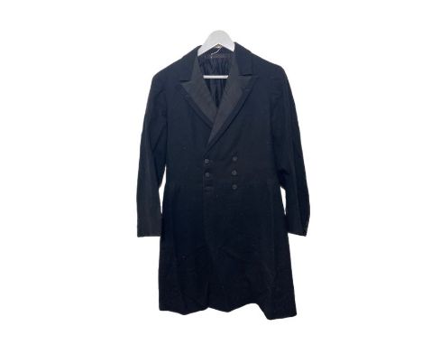 An early 20th century frock coat, some button fly tweed plus fours and a pair of early 20th century black leather gaiters. (3
