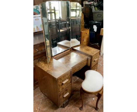 An Art Deco burr walnut pedestal dressing table, inverted shape, curved rectangular held two pine holders, a frieze drawer ov