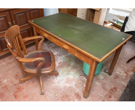 A first half 20th century oak swivel office chair, leather seat; an oak desk and an oak filing cabinet (3)