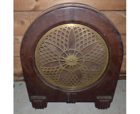 An early 20th century speaker with pierced brass grille and arched brown bakelite case