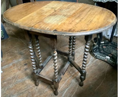 An early 20th oak gateleg table, in an 18th century manner, oval top dropleaf, raised on barley twisted supports. 73cm H; ano