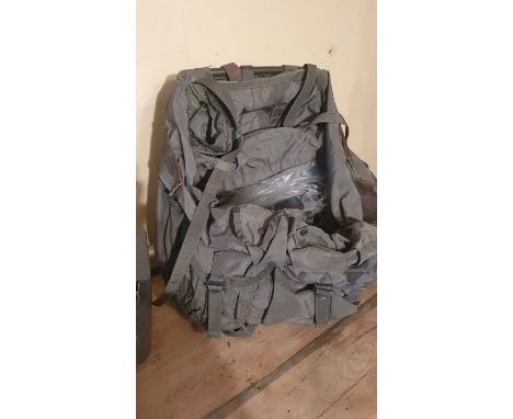 A box of military style trousers, a military backpack and an Airforce Camera AF.