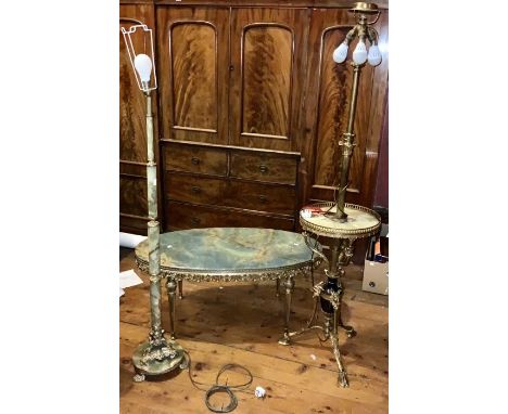 A 20th Century onyx and gilt oval low table; two similar standing lamp (2)