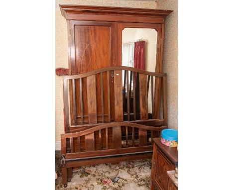 An Edwardian mahogany bedroom suite, comprising double wardrobe with one mirrored door and one inlaid door above two short dr