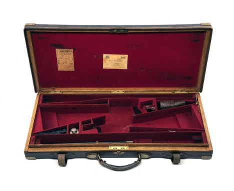 JAMES PURDEY &amp; SONS A BRASS-CORNERED OAK AND LEATHER DOUBLE GUNCASE, fitted for 28in. barrels, the interior lined with re