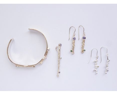 A contemporary white-metal and gemstone demi-parure, comprising bangle, pendant necklace and two pairs of pendant earrings, e