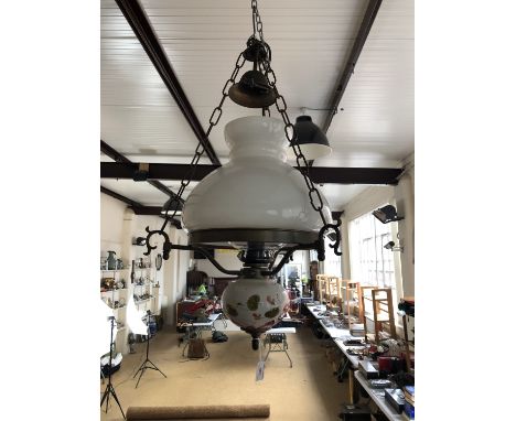 A pendant ceiling light modelled as a Victorian oil lamp with glass shade 