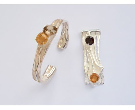 A contemporary white-metal demi-parure, comprising pendant and bangle, each of an organic sinuous design incorporating oval-c