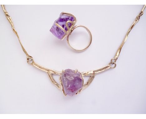 A contemporary white-metal mounted amethyst demi-parure, comprising necklace and cocktail ring, the rough-cut stone claw set 