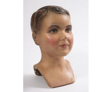 An early 20th century plaster advertising bust or mannequin head of a young boy, circa 1930s:, with moulded hair and painted 